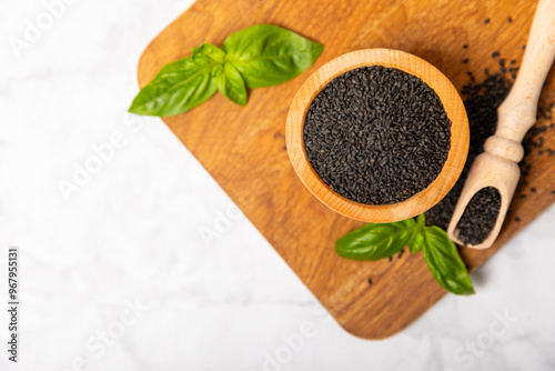 Basil seeds on textured wooden background. Close-up. Superfood. Ocimum basilicum. Organic basil seeds. selasih. Space for text. Copy space. photo