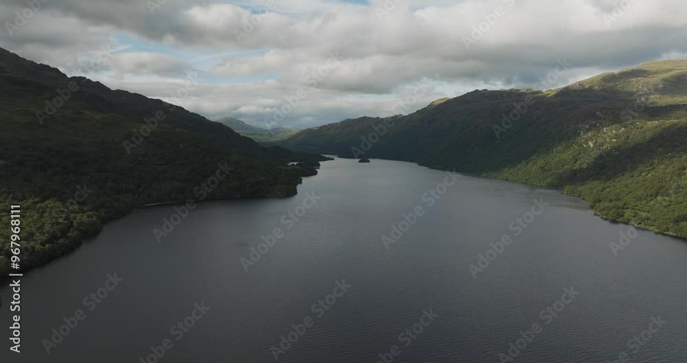 Aerial view of tranquil Loch Ness surrounded by majestic mountains and serene greenery, Fort Augustus, United Kingdom. Aerial view of tranquil Loch Ness surrounded by majestic mountains and serene greenery, Fort Augustus, United Kingdom.
