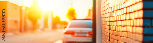 A police car is patrolling quiet, clean street during sunset, creating serene yet vigilant atmosphere. warm light enhances peaceful environment photo