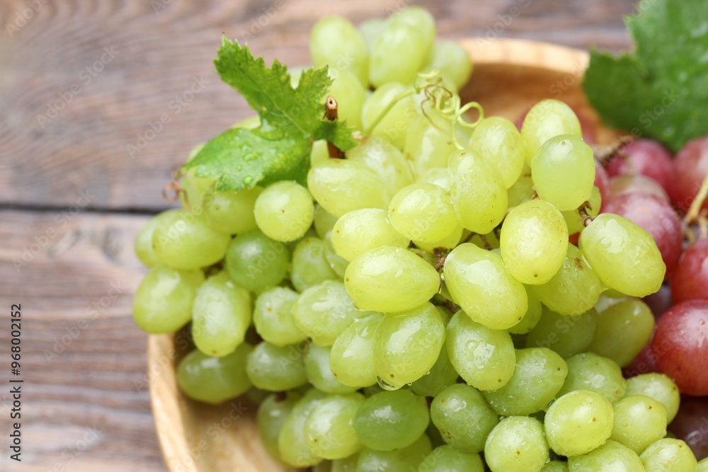 Fresh ripe grapes on wooden table, closeup Fresh ripe grapes on wooden table, closeup