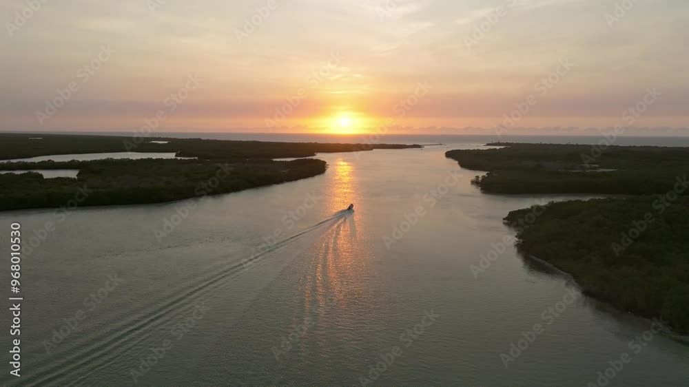 Aerial view of serene sunset over tranquil marshland and coastline with boats, Progreso, Mexico. Aerial view of serene sunset over tranquil marshland and coastline with boats, Progreso, Mexico.