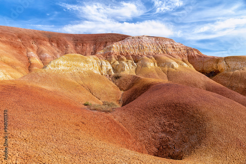 Akzhar Ulytau chalk mountains in the desert of Kazakhstan. Rare sandy hills with many multi-colored layers of clay, sand, chalk and gravel of bizarre shape far from civilization with sparse vegetation photo