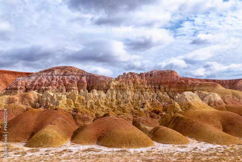 Akzhar Ulytau chalk mountains in the desert of Kazakhstan. Rare sandy hills with many multi-colored layers of clay, sand, chalk and gravel of bizarre shape far from civilization with sparse vegetation