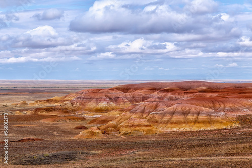 Akzhar Ulytau chalk mountains in the desert of Kazakhstan. Rare sandy hills with many multi-colored layers of clay, sand, chalk and gravel of bizarre shape far from civilization with sparse vegetation photo