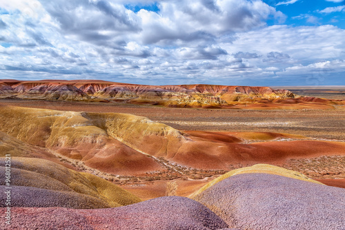 Akzhar Ulytau chalk mountains in the desert of Kazakhstan. Rare sandy hills with many multi-colored layers of clay, sand, chalk and gravel of bizarre shape far from civilization with sparse vegetation photo