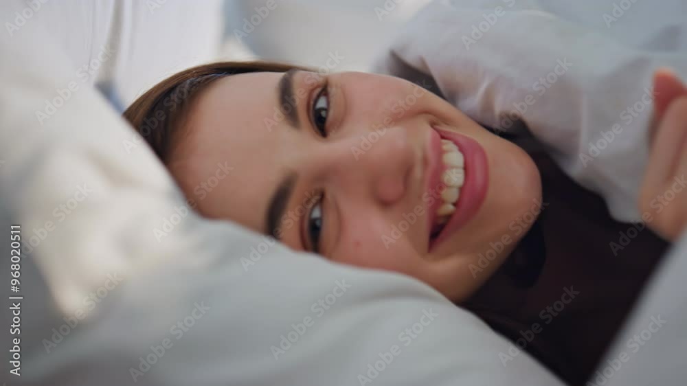 Closeup woman lying blanket in bed feeling happy closeup. Smiling lady relaxing 