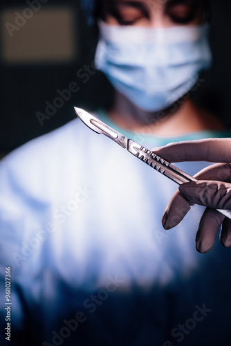 Surgeon holding a scalpel in surgery