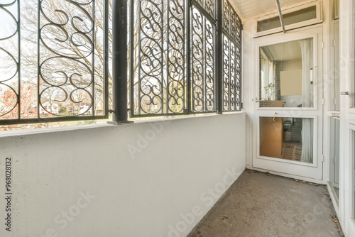 Bright sunroom with ornate ironwork and open space photo