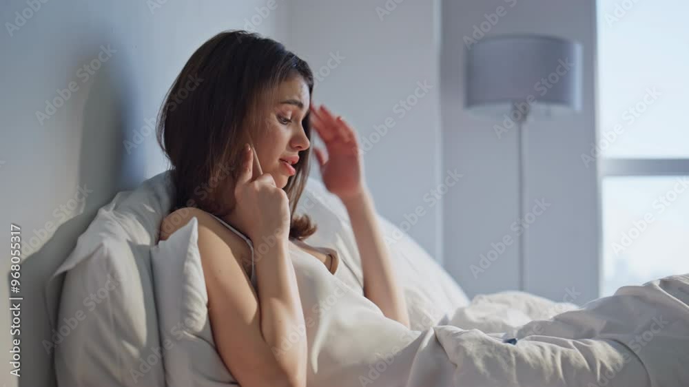 Ill woman complaining temperature by mobile phone call sitting home bed closeup. Ill woman complaining temperature by mobile phone call sitting home bed closeup.