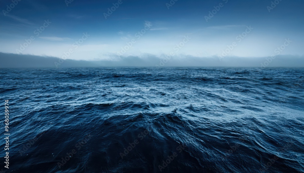 Serene Ocean Horizon at Dawn. Calm Blue Waters Meeting a Clear Sky with Gentle Dark Mist Rolling Over Distant Mountains, Creating a Peaceful and Expansive Coastal Scene in Early Morning Light Serene Ocean Horizon at Dawn. Calm Blue Waters Meeting a Clear Sky with Gentle Dark Mist Rolling Over Distant Mountains, Creating a Peaceful and Expansive Coastal Scene in Early Morning Light