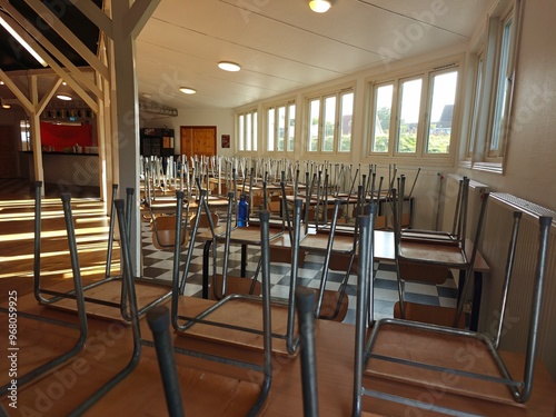 Upside-down chairs on tables in a hall, non-residential space