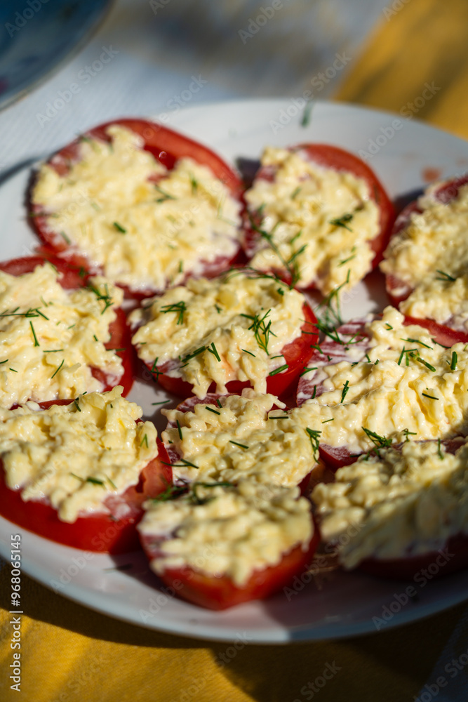 Tomatoes with cheese. Tomatoes sliced with cheese and sprinkled with dill on top Tomatoes with cheese. Tomatoes sliced with cheese and sprinkled with dill on top