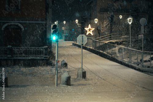 Canvas Print Moody evening night in the city during a snowfall on New Years Eve, Aprica, Nort