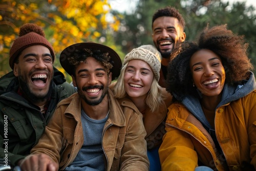 group of diverse friends, one in a wheelchair, happily enjoying each other's company in a park setting.