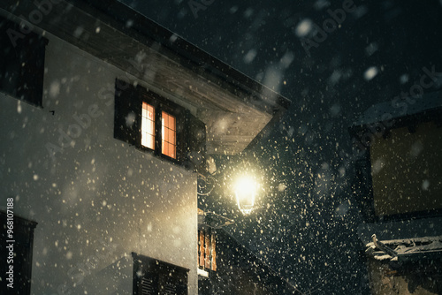 Moody evening night in the city during a snowfall on New Years Eve, Aprica, Northern Italy photo