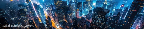 A vibrant aerial view of a cityscape at night, illuminated with colorful lights from buildings and streets below. Free copy space for banner.