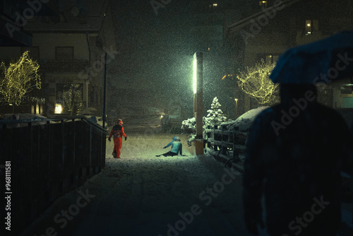 Photography A group of children playing in the snow during a moody night in the city during