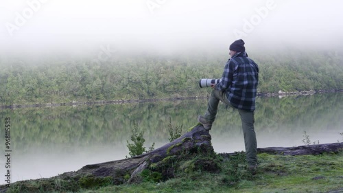 photografer sitting on the edge of the lake