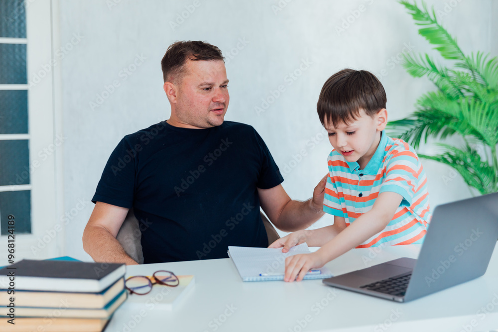 Man and boy with online laptop studying and working on the Internet Man and boy with online laptop studying and working on the Internet