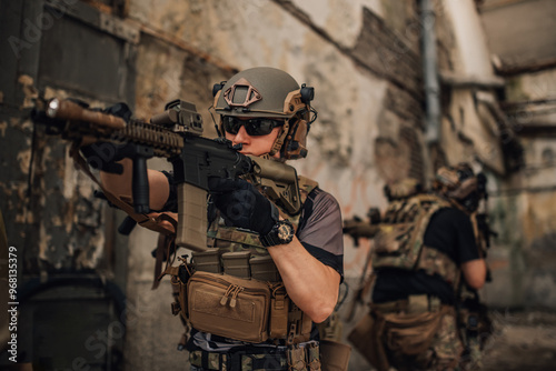 Brave soldier with sniper rifle shooting at enemy at crashed building.