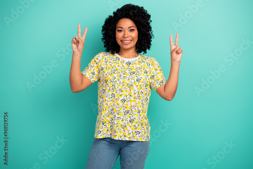 Photo of shiny attractive lady dressed print t-shirt showing v-sign empty space isolated teal color background