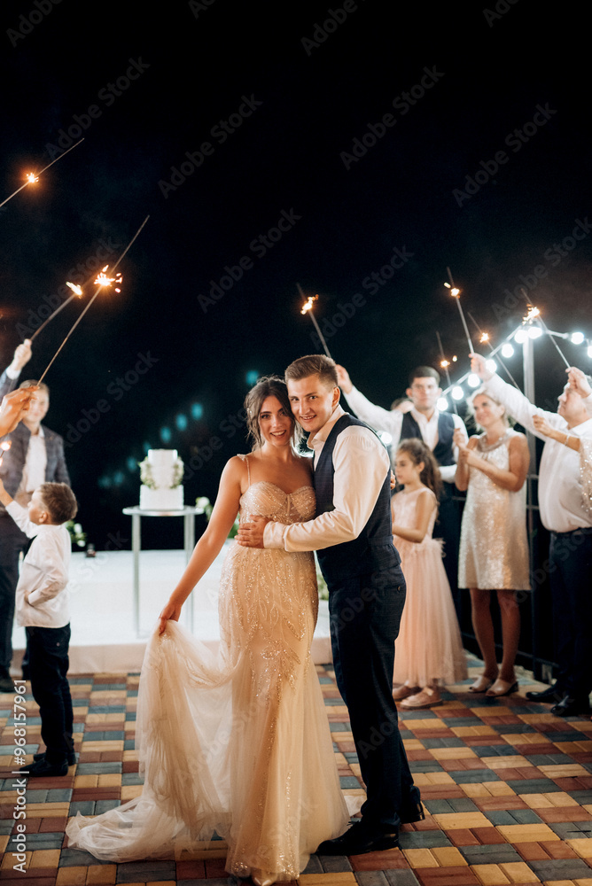 newlyweds at a wedding of sparklers