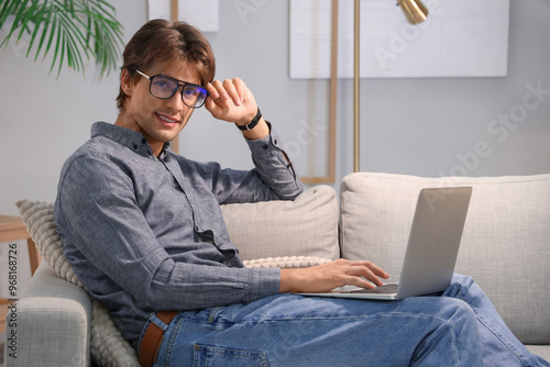 Happy young businessman sit...
