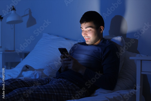 Young man using mobile phon...