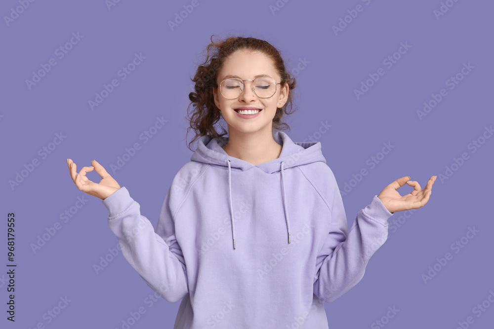 Portrait of relaxed young woman meditating on purple background Portrait of relaxed young woman meditating on purple background