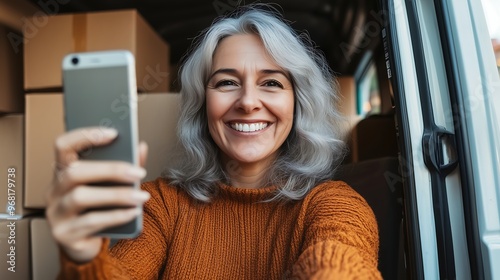 Smiling Woman Taking a Selfie in a Delivery Van photo