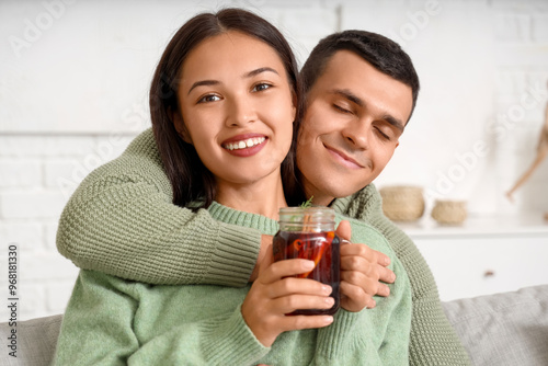 Happy couple with glass of ...