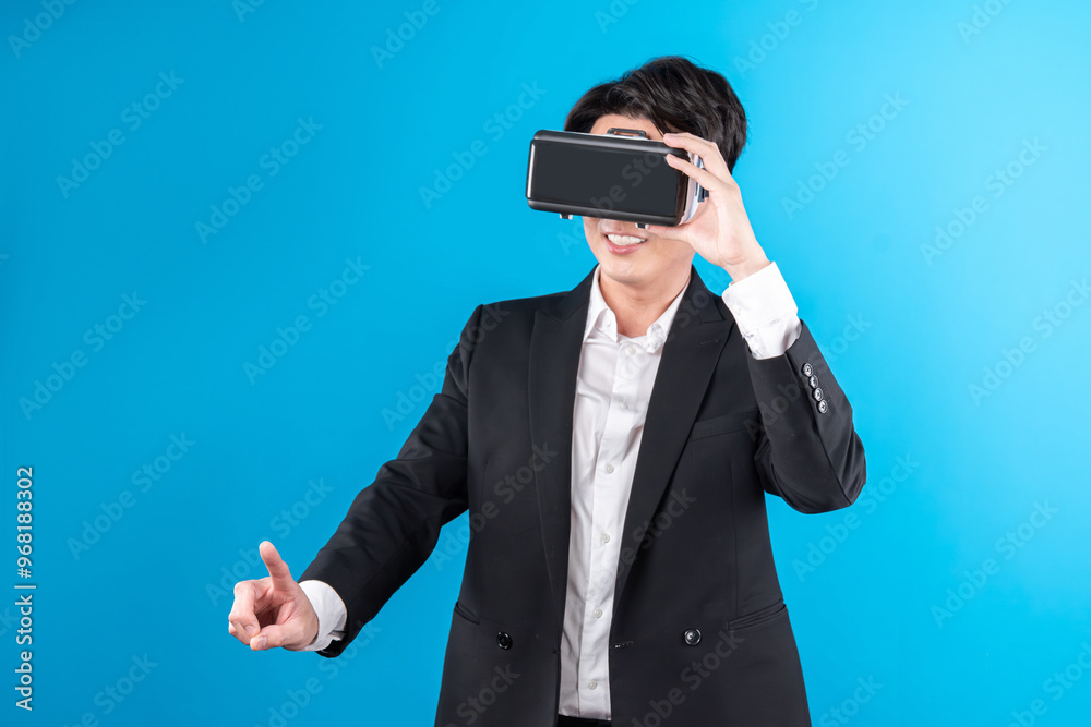 Asian businessman looking thorough VR while touching screen with connecting business world report in futuristic metaverse analyzing innovation technology virtual reality blue copyspace. Contrivance. Asian businessman looking thorough VR while touching screen with connecting business world report in futuristic metaverse analyzing innovation technology virtual reality blue copyspace. Contrivance.