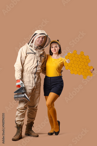 Male beekeeper with smoker ...