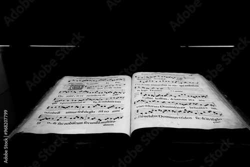 ancient book of choral singing from 1608 preserved in the cathedral of cefalù, palermo, during a summer visit to the church photo