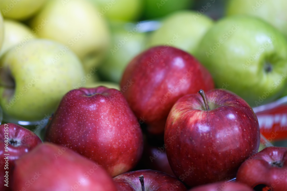 Fresh red and green apples as background, selective focus. Jewish holiday Rosh Hashana. Traditional food of New Year Rosh Hashanah concept. Jewish new year composition of an apple, festive backdrop. Fresh red and green apples as background, selective focus. Jewish holiday Rosh Hashana. Traditional food of New Year Rosh Hashanah concept. Jewish new year composition of an apple, festive backdrop.