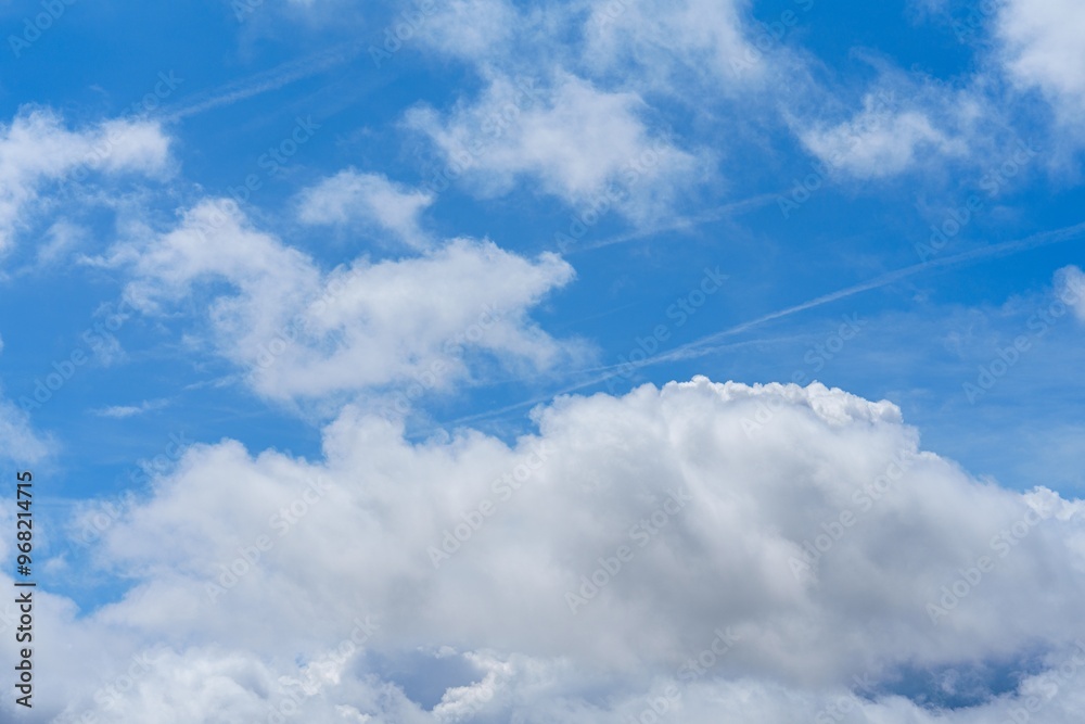 This high-resolution image showcases a vibrant blue sky filled with fluffy white clouds and delicate cirrus strands, making it an ideal background for various digital projects including websites and This high-resolution image showcases a vibrant blue sky filled with fluffy white clouds and delicate cirrus strands, making it an ideal background for various digital projects including websites and