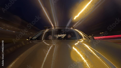 Timelapse of car driving on busy city streets at night. Drivelapse. road with lights reflected photo