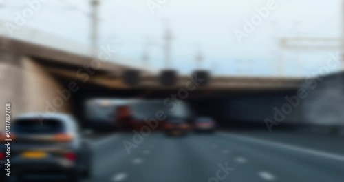 Defocused slow-motion view of a driver on a large highway with a car ahead, portraying a blurry and disoriented perspective, symbolizing the concept of impaired driving