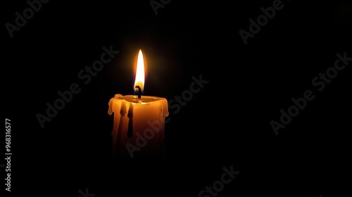 A single candle burning brightly in the dark, casting a warm, flickering glow in an otherwise pitch-black room.