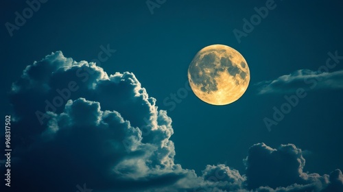 A supermoon rising, appearing larger than usual in the night sky, with clouds drifting across it. photo