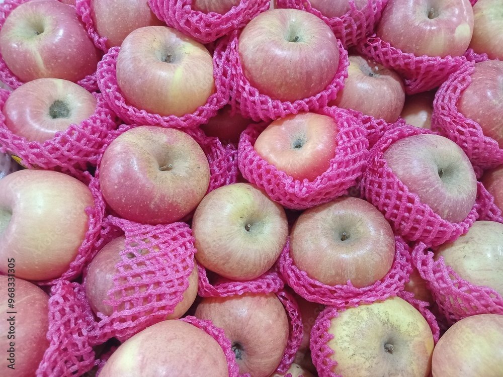 Bunch of apples on display. Apple sold in the traditional market. Organic apples that are pink, sweet, and contain vitamin C. Bunch of apples on display. Apple sold in the traditional market. Organic apples that are pink, sweet, and contain vitamin C.