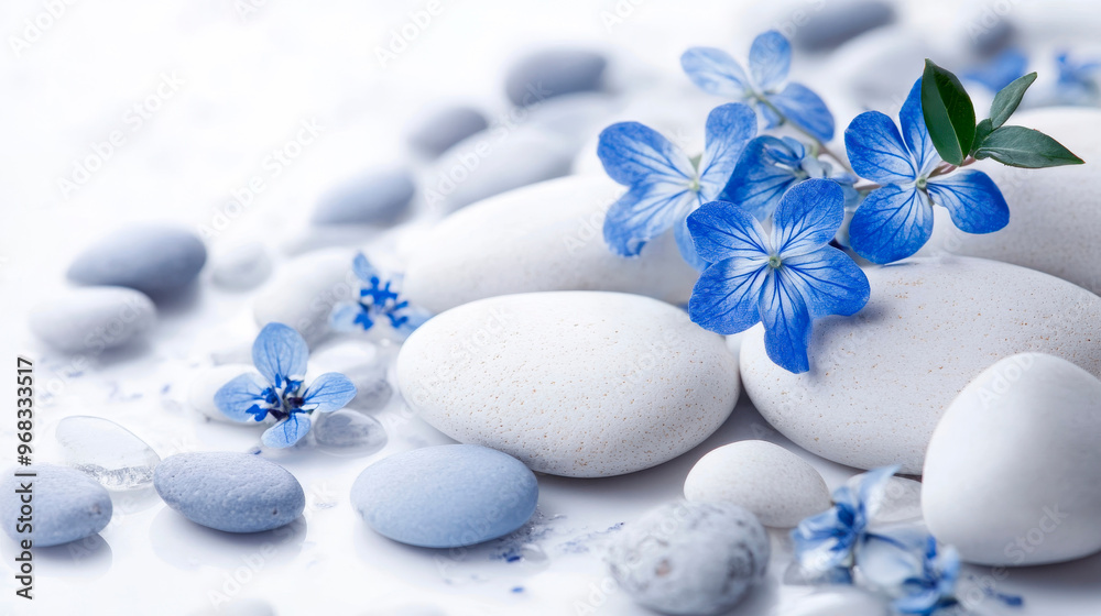 Carefully arranged white smooth pebbles with delicate blue flowers in a minimalist style. Harmonious composition with blue pebbles and leaves. Carefully arranged white smooth pebbles with delicate blue flowers in a minimalist style. Harmonious composition with blue pebbles and leaves.