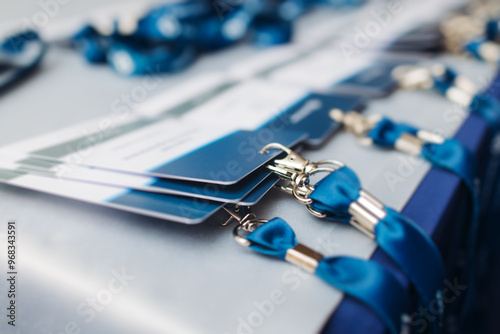 Process of checking in on conference congress forum event, registration desk table, visitors and attendees receiving lanyard with name badge and entry wristband bracelet and register electronic ticket