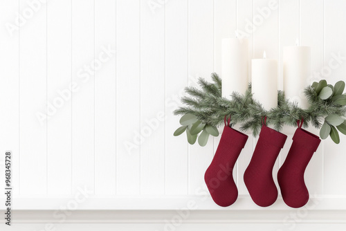 Festive scene with red stockings and white candles surrounded by greenery, perfect for holiday decoration and celebration. photo