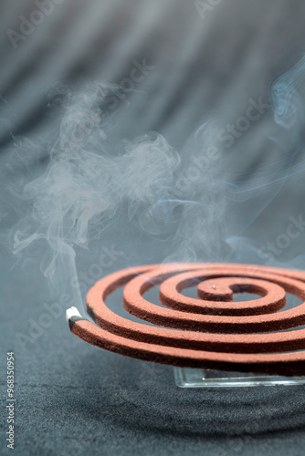 A mosquito coil with smoke coming out of it photo