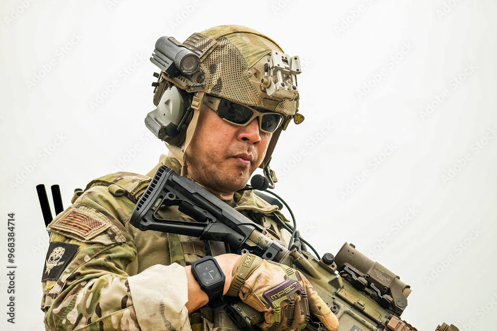 Fototapeta premium A group of military men in combat gear patrol in the middle of a desert and tropical jungle. Soldiers in full combat gear in dry weather conditions assemble and march on a mission.