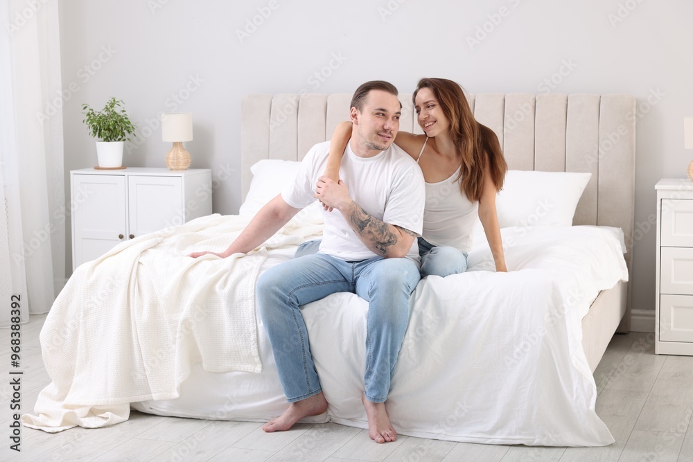 Happy couple spending time together on bed at home Happy couple spending time together on bed at home