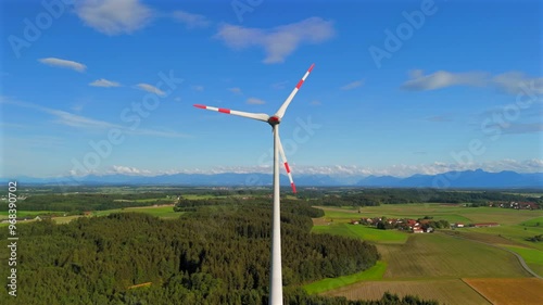 Aerial view of wind turbine in Bavaria, Ebersberg region, Germany. Luftaufnahme einer Windturbine vor dem Hintergrund der Alpen in Bayern, Deutschland. Wind turbine on golf course overlooking alps.  photo