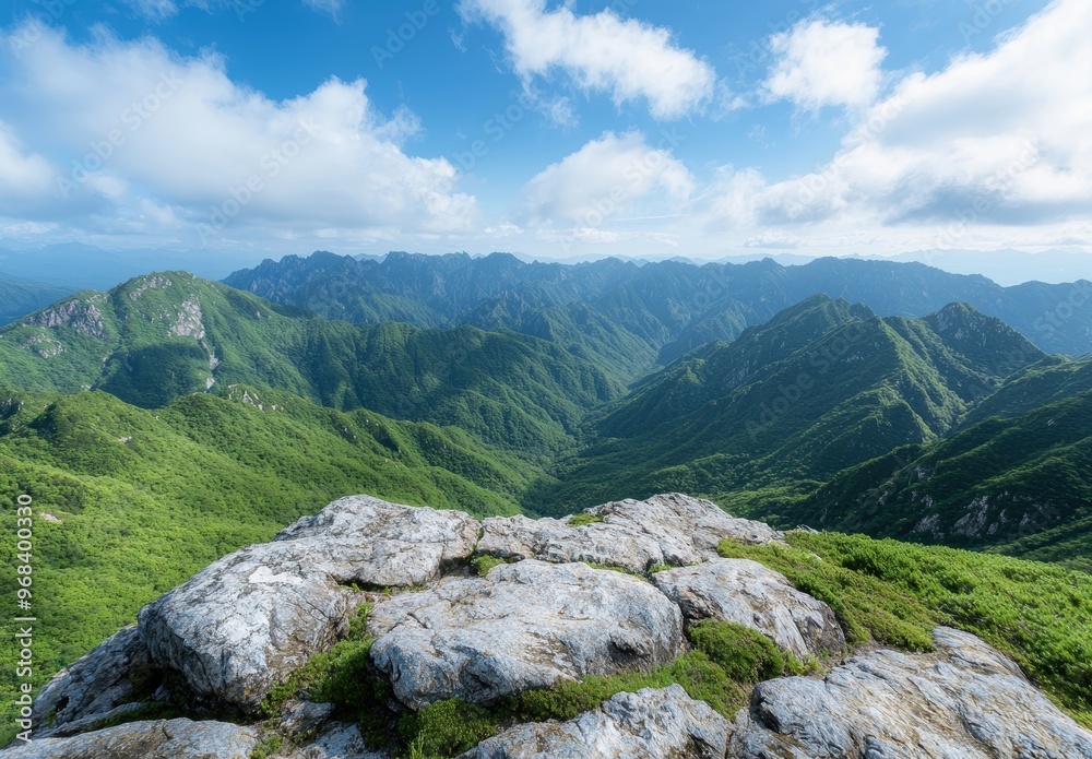 Fototapeta premium Breathtaking mountain landscape with lush green hills and blue sky