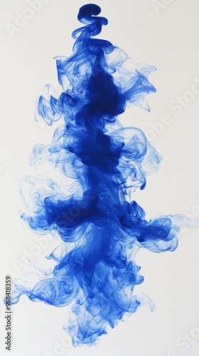 Blue ink in water creating swirling cloud, abstract art concept